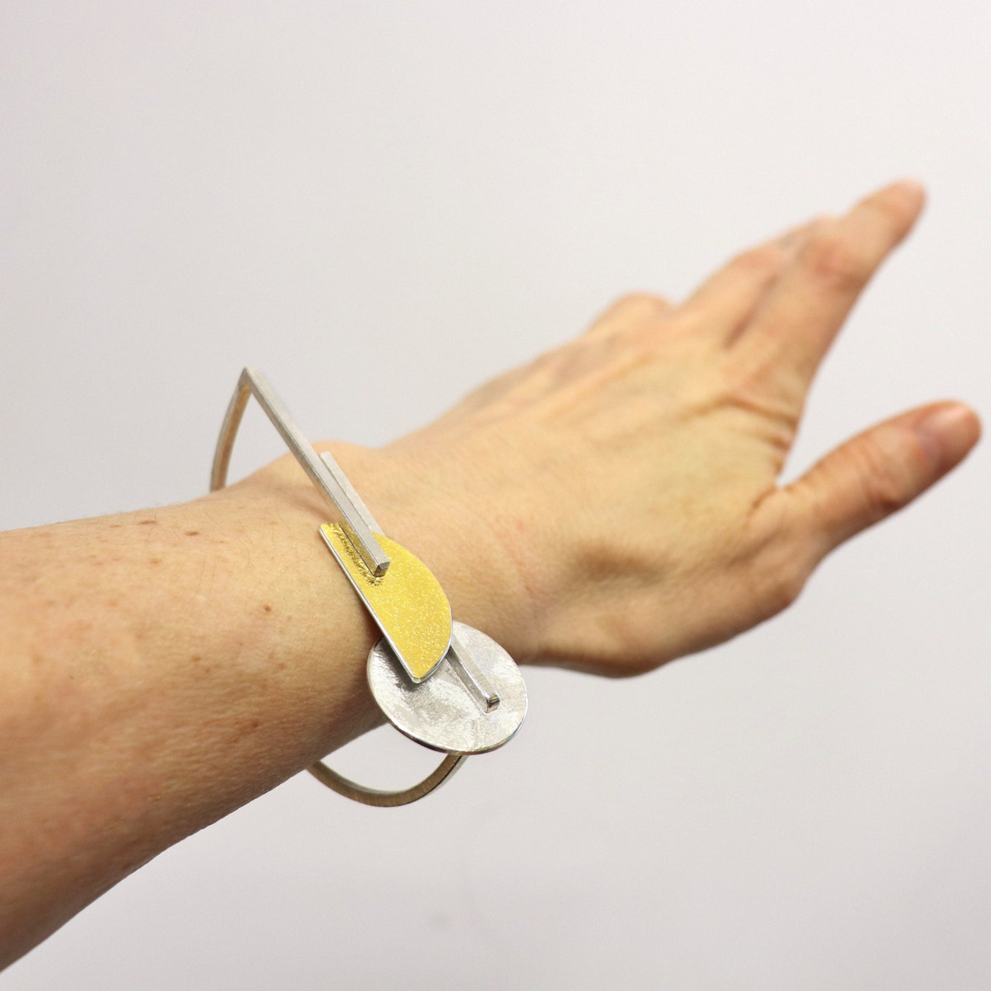 Inverse-D bauhaus bangle silver gold architectural