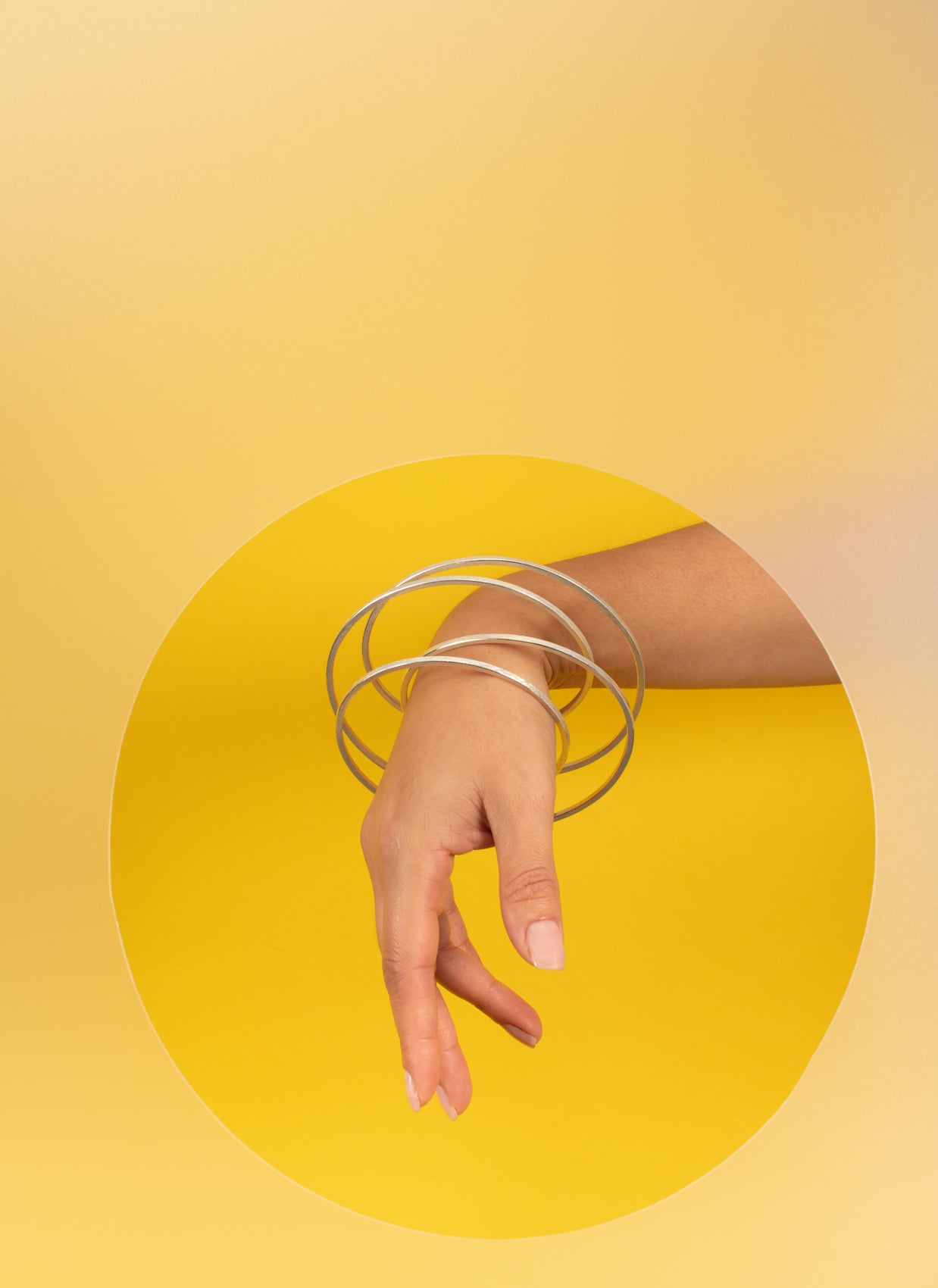 yellow portrait modelled silver vortex bangle
