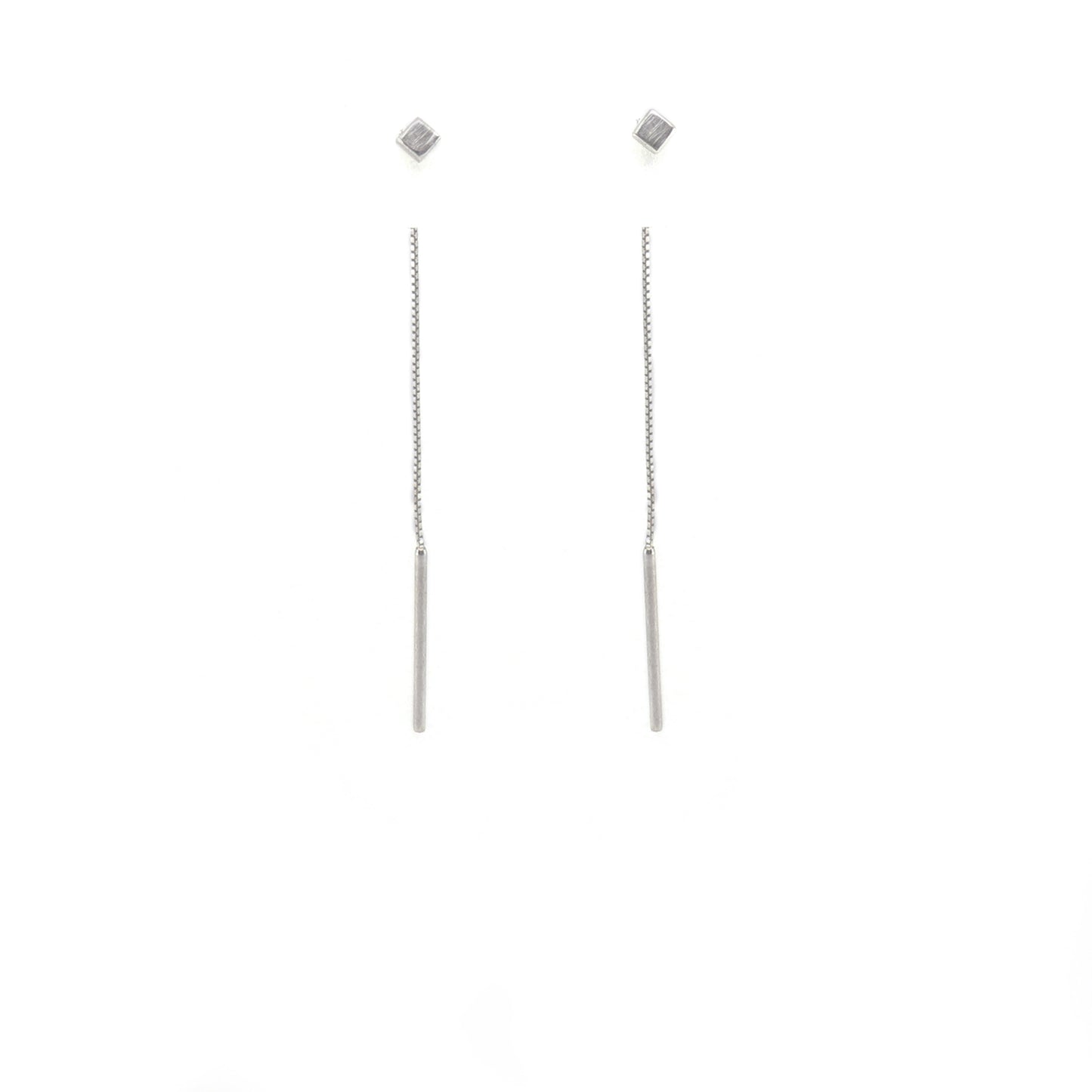 Pair of silver cube threader earrings on a white background