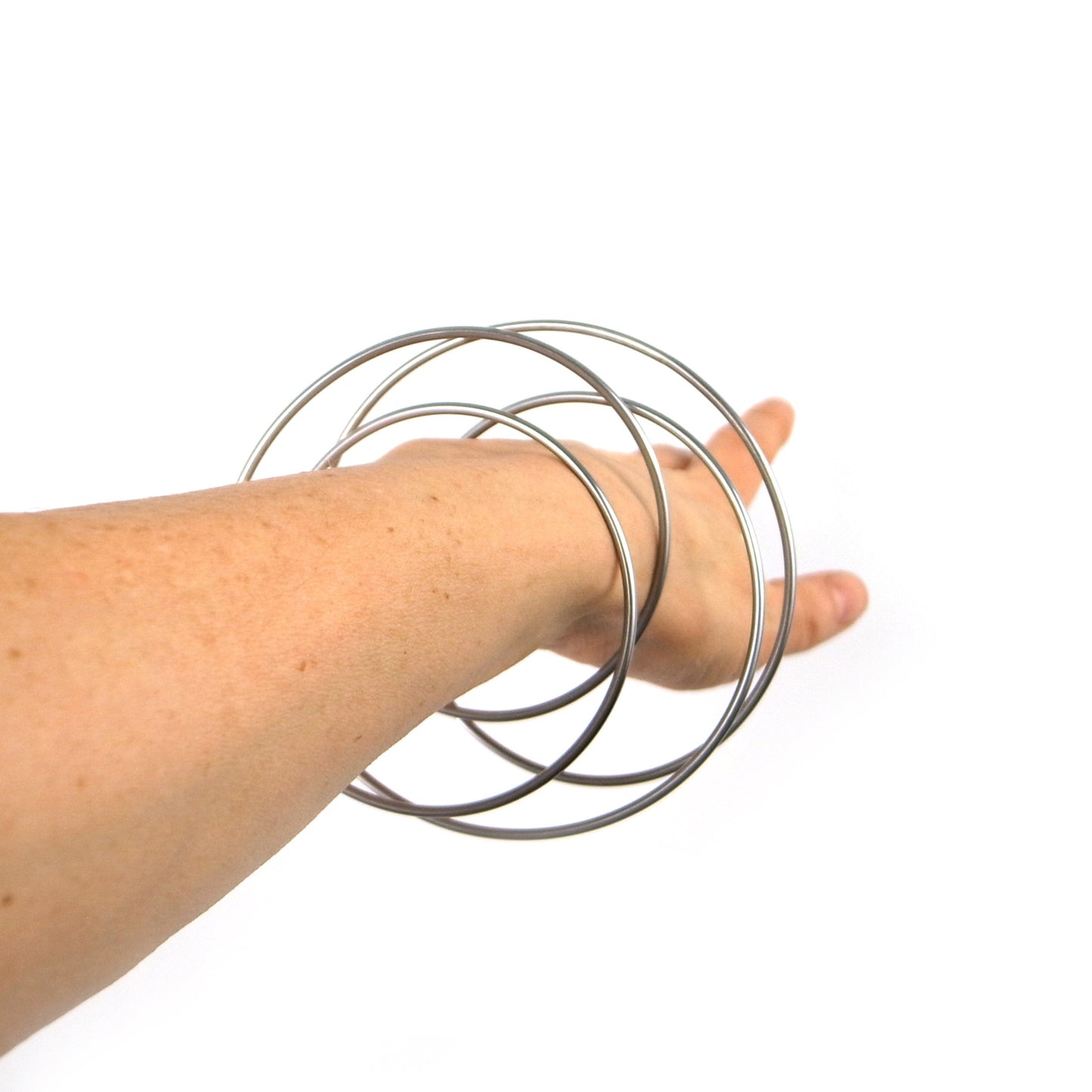Minimal steel bangle modelled by DeeLyn Design