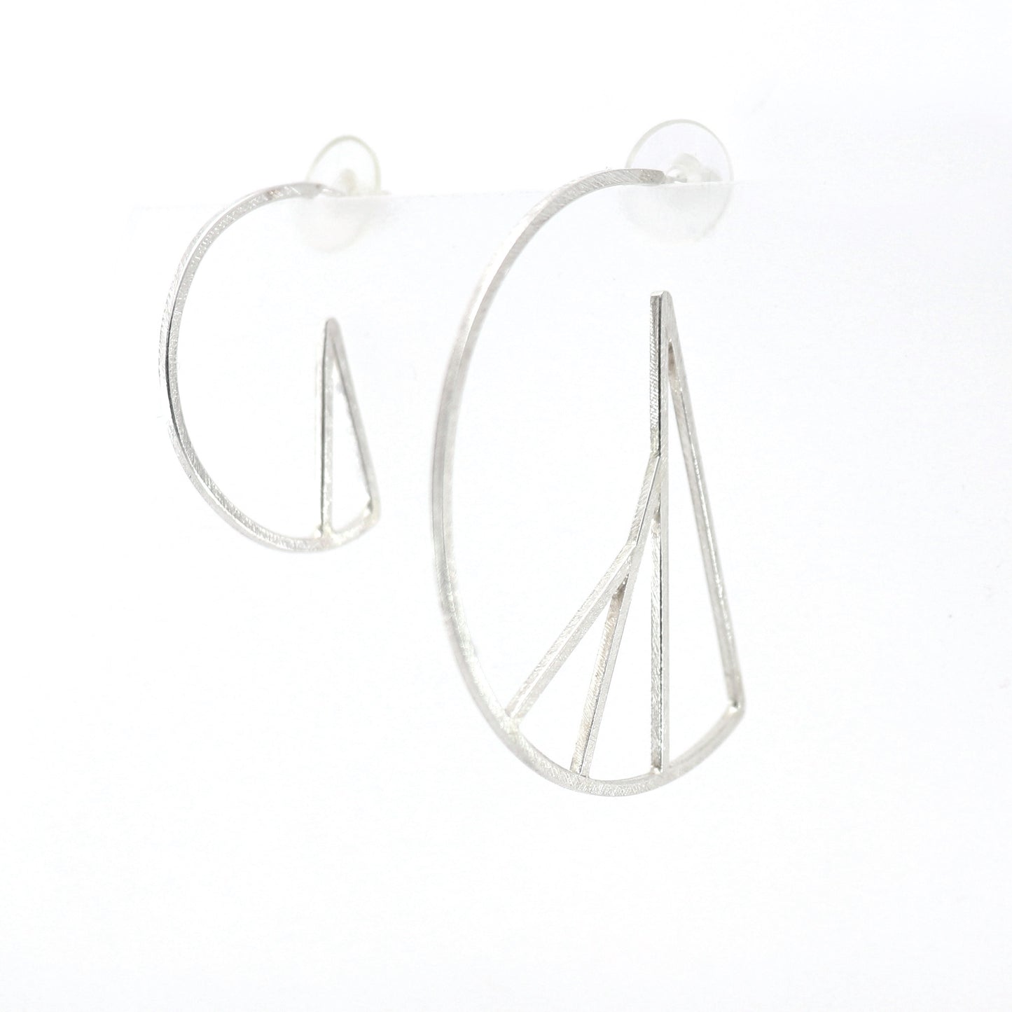 Silver hoop earrings with vertical bars on a white background
