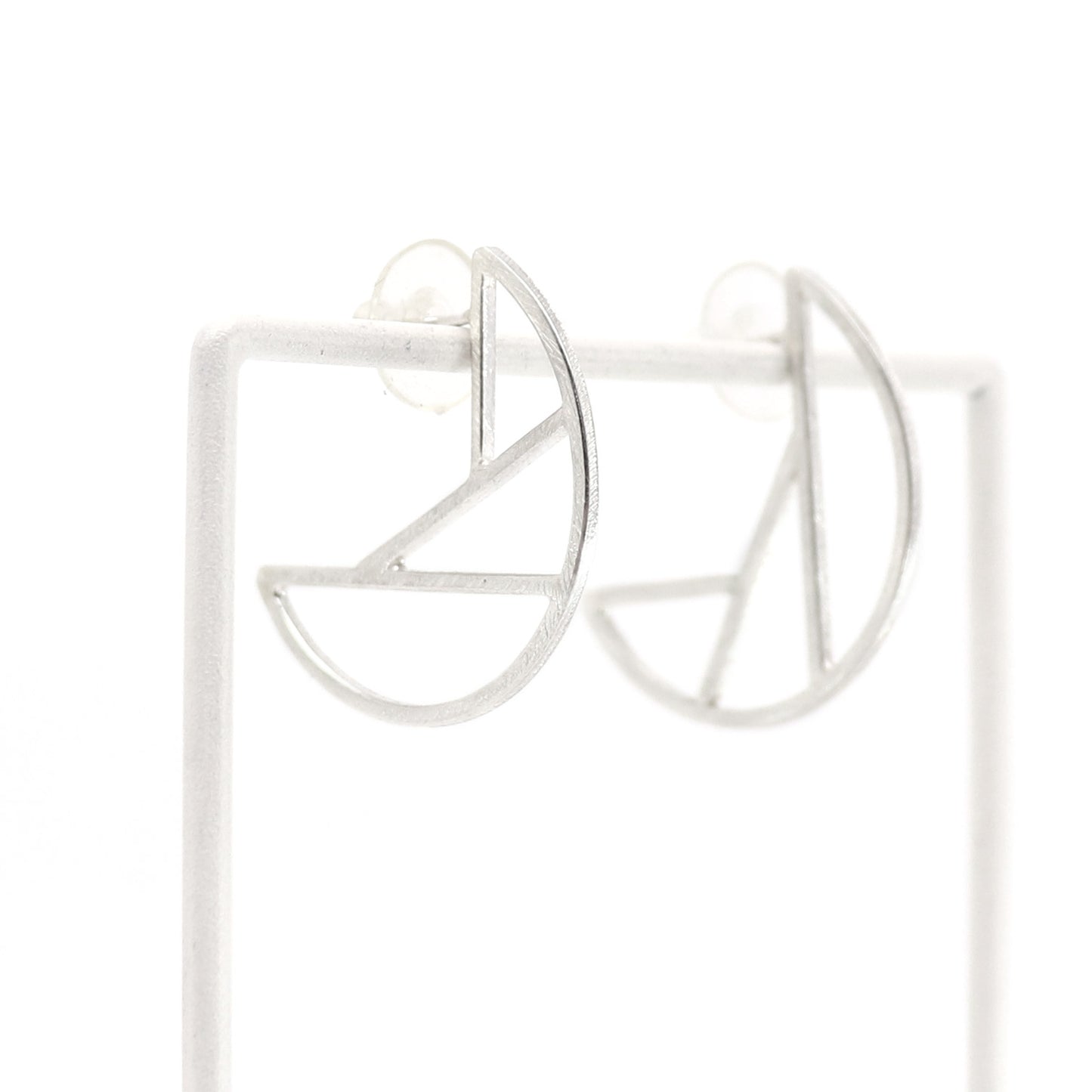 Silver geometric hoop earrings on a white background