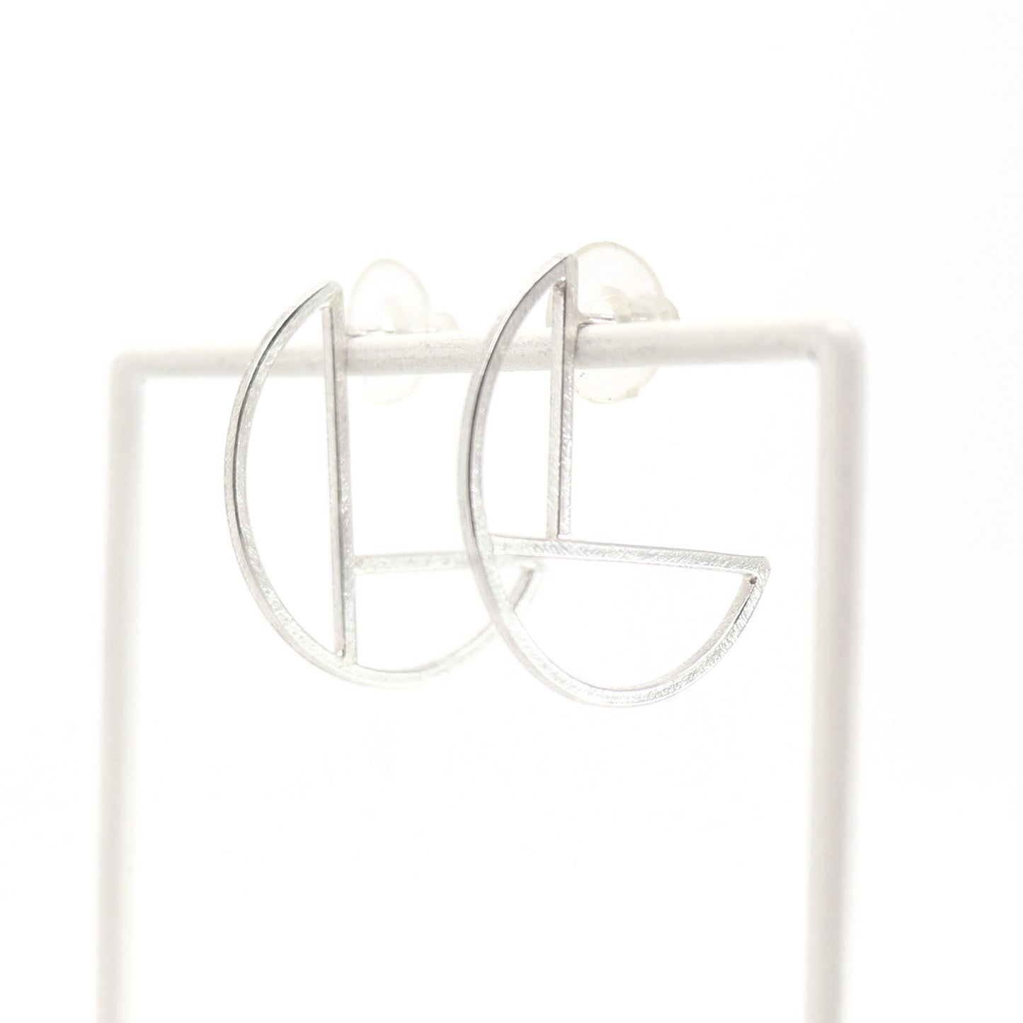 Pair of silver hoop earrings on a white background
