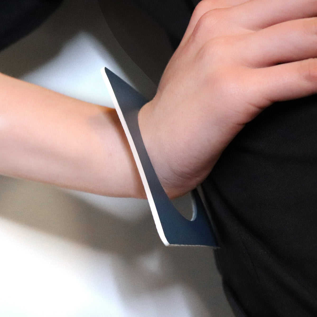navy blue linoleum square bangle made of linoleum hand on hip