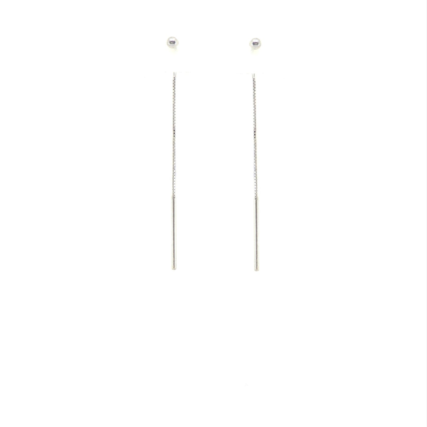 Pair of long thin ball threader earrings in sterling silver on a white background