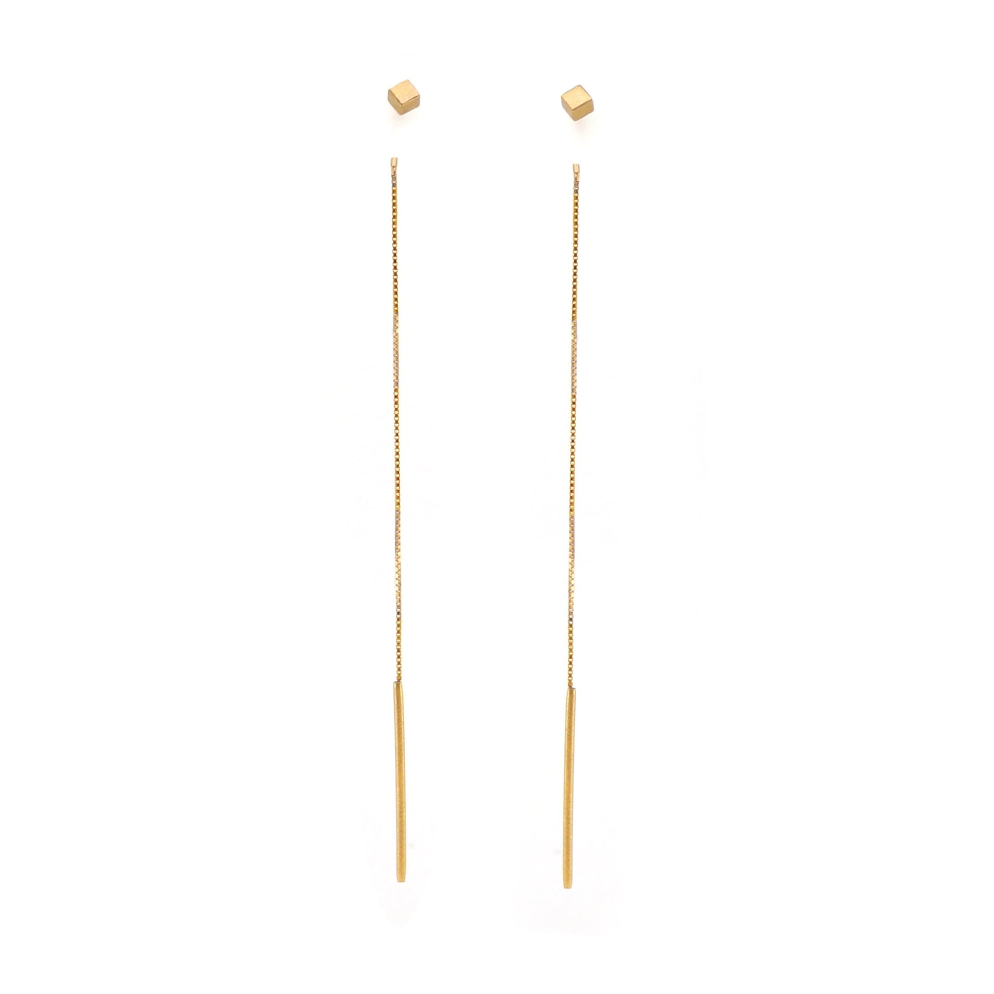 Gold cube threader earrings on a white background