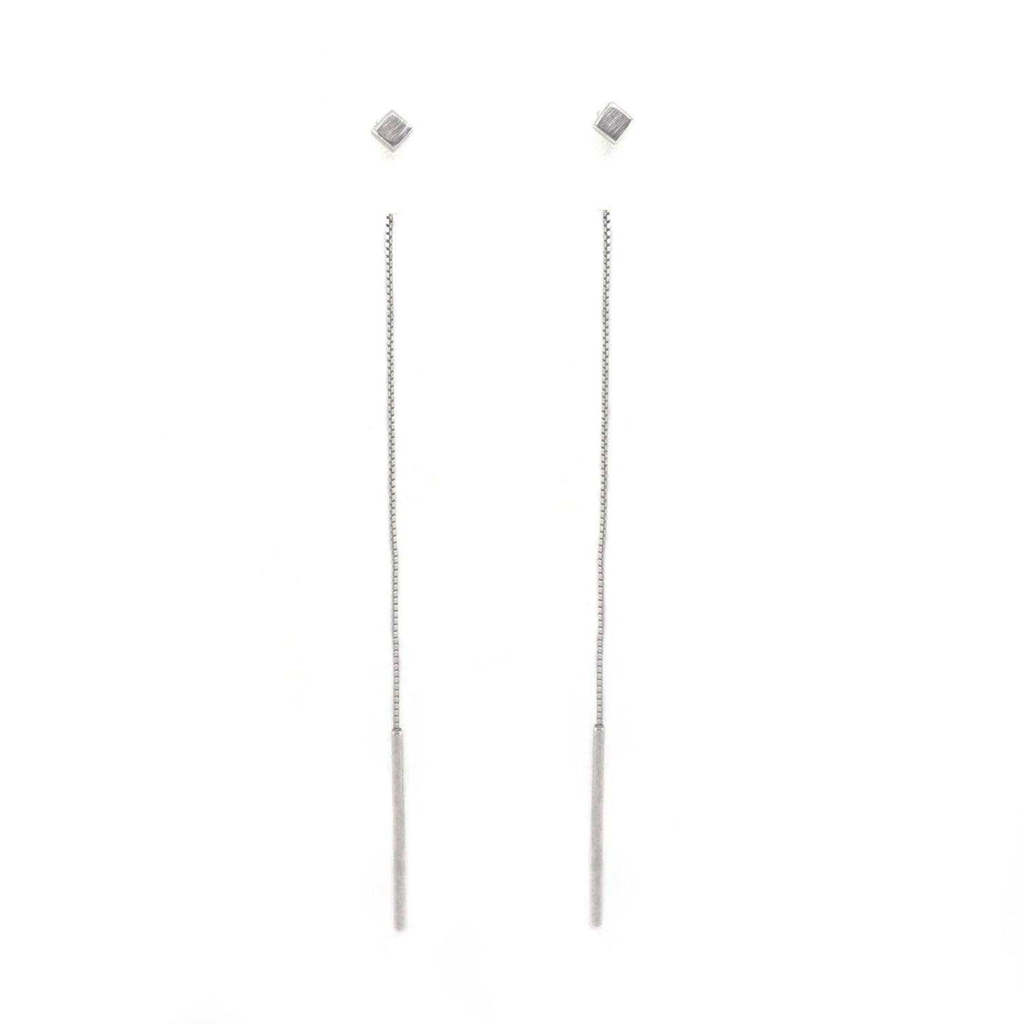 Pair of cube silver long thread earrings on a white background