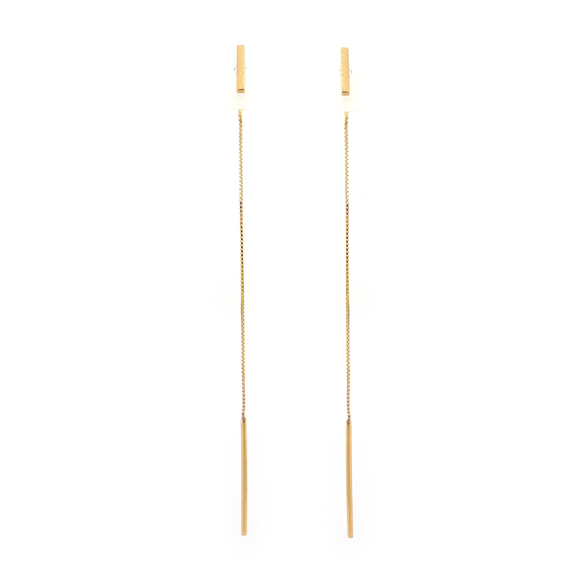 Pair of bar gold earrings on a white background