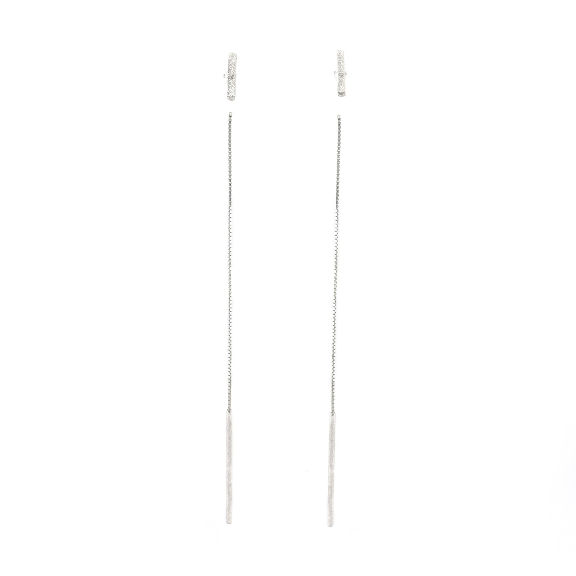 Pair of silver chain earrings on a white background
