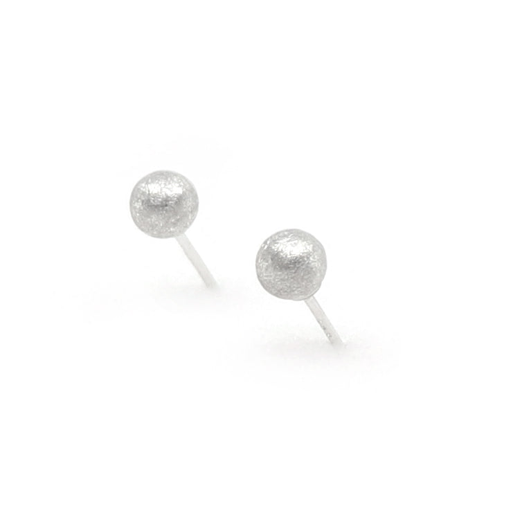 Pair of silver stud earrings on a white background