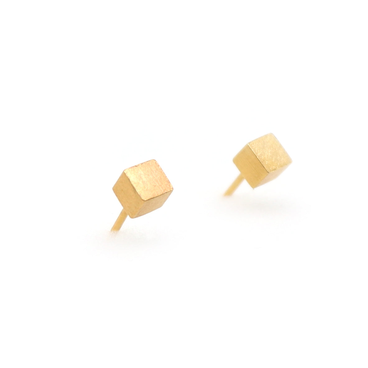 Gold geometric stud earrings on a white background