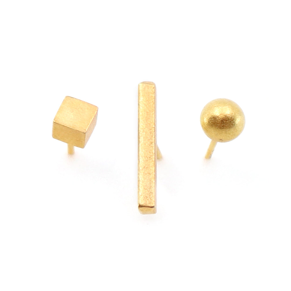 Gold square, bar, and sphere earrings on a white background
