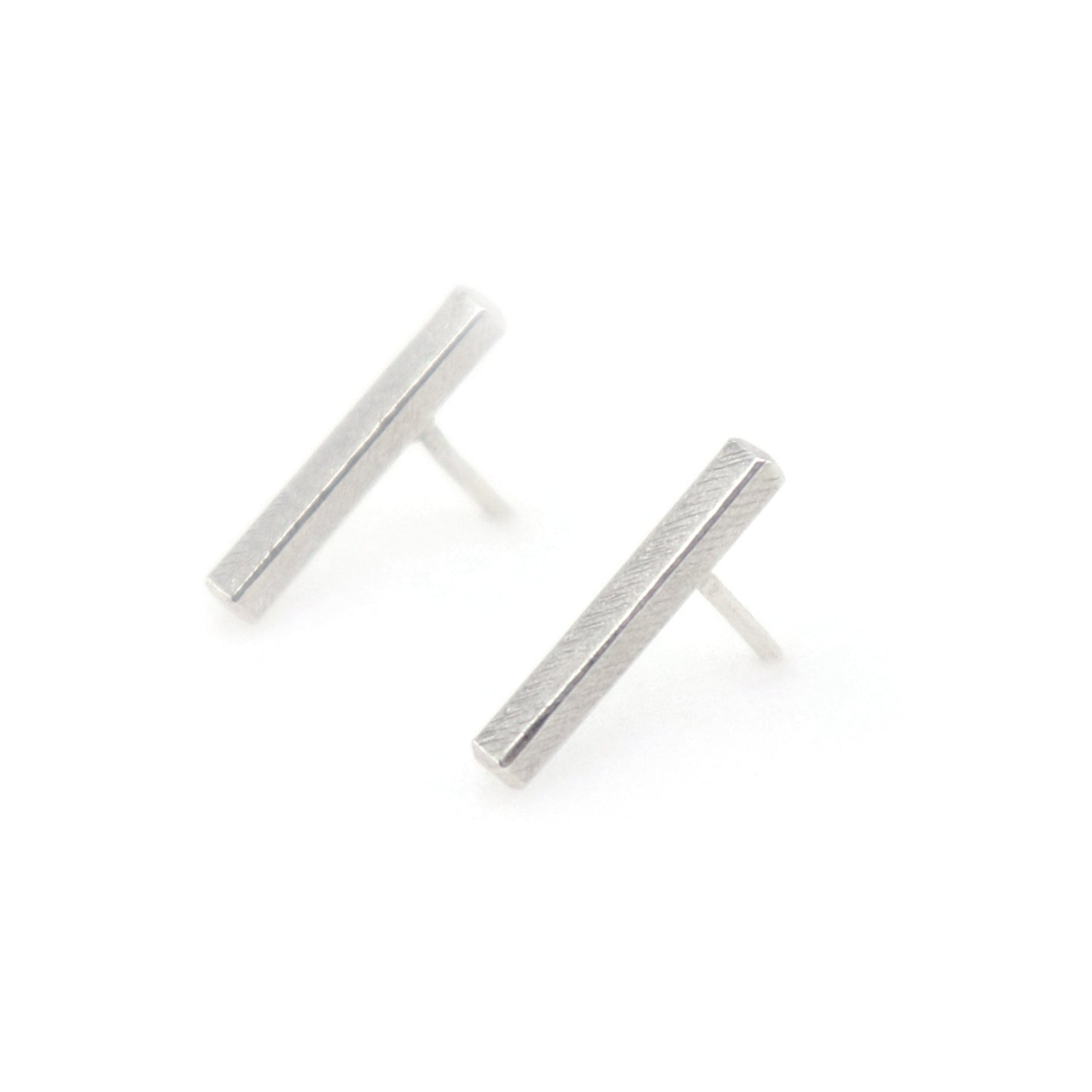 Pair of silver bar earrings on a white background