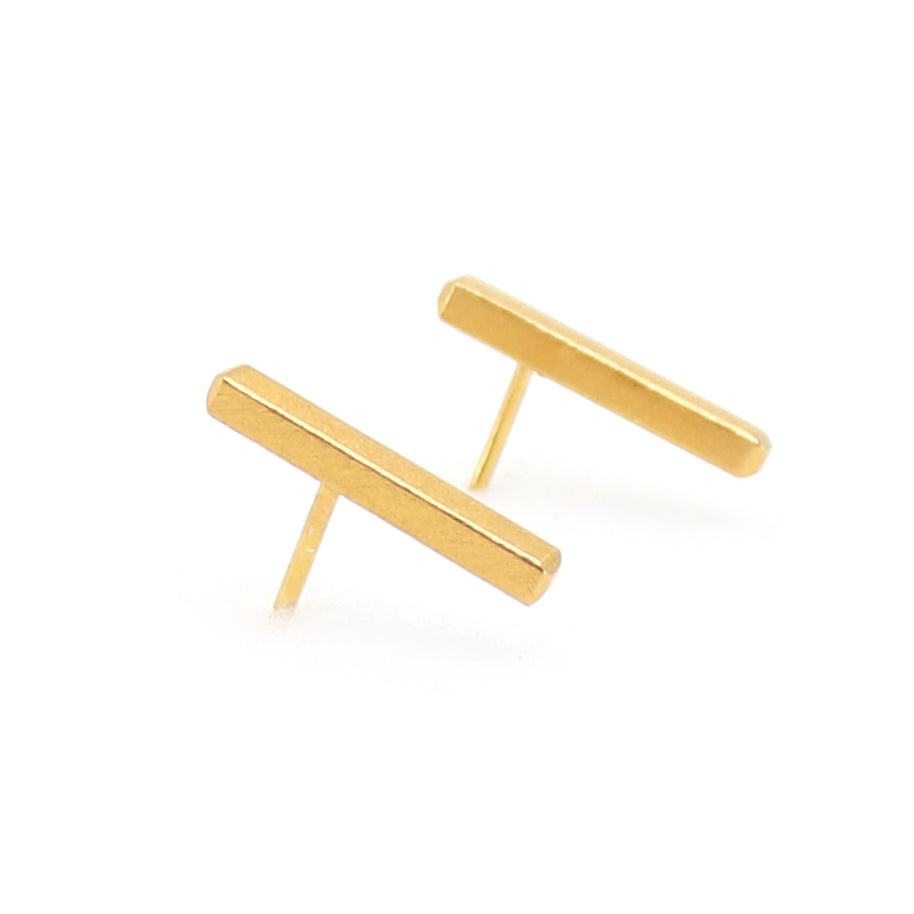 Gold bar earrings on a white background