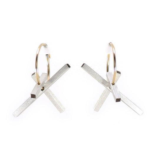 Pair of gold hoops earrings with silver rectangles on a white background