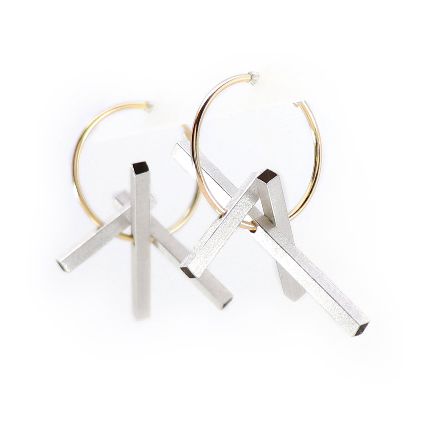 Gold hoop earrings with silver rectangle moving components on a white background