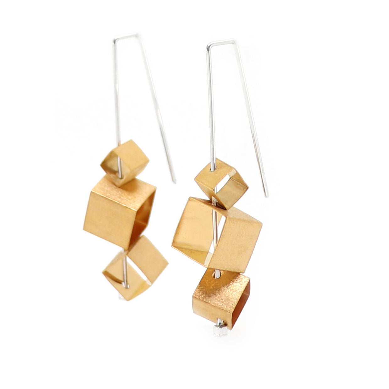 Gold brutalist cubes on sterling silver wire drop earrings on a white background