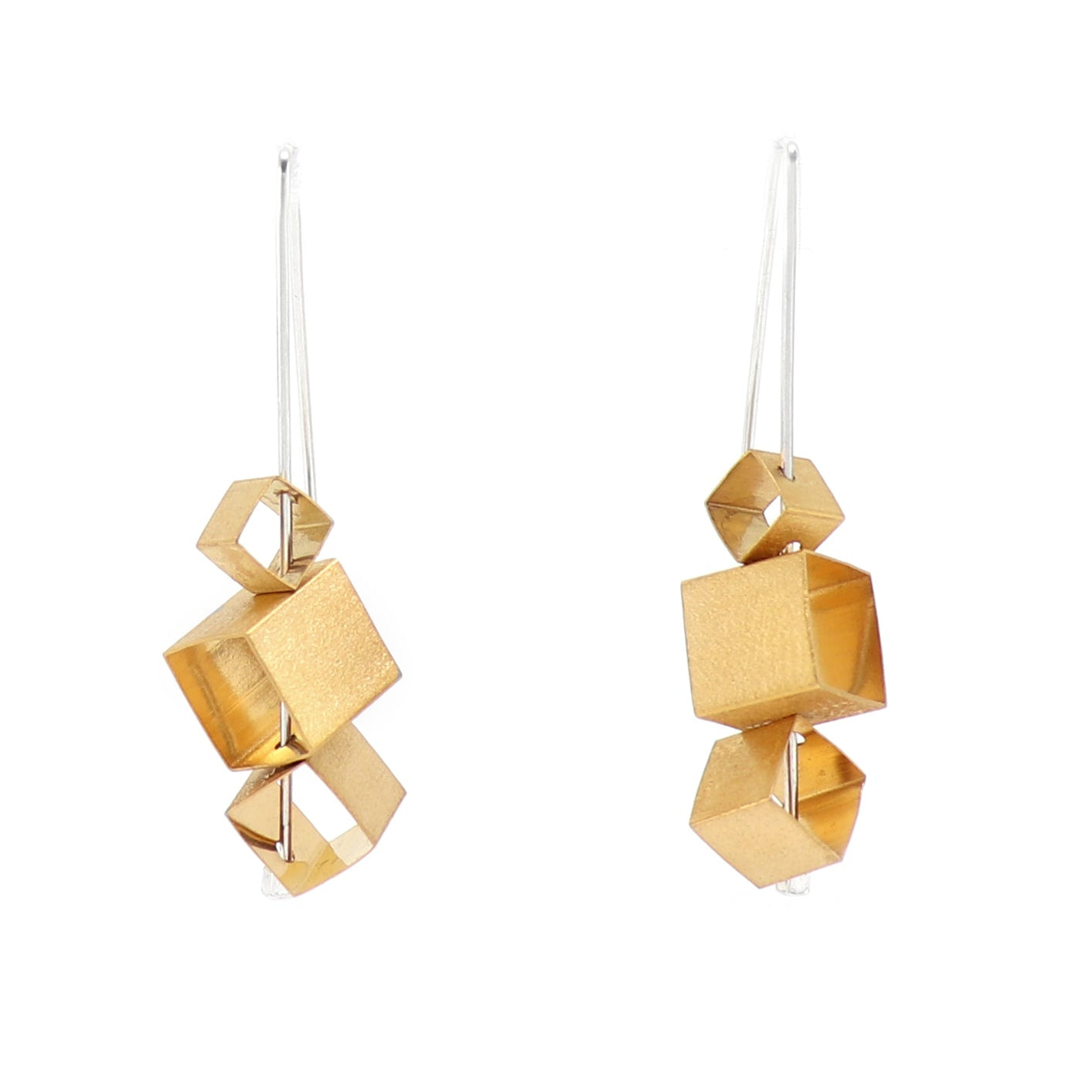 Gold geometric earrings on a white background