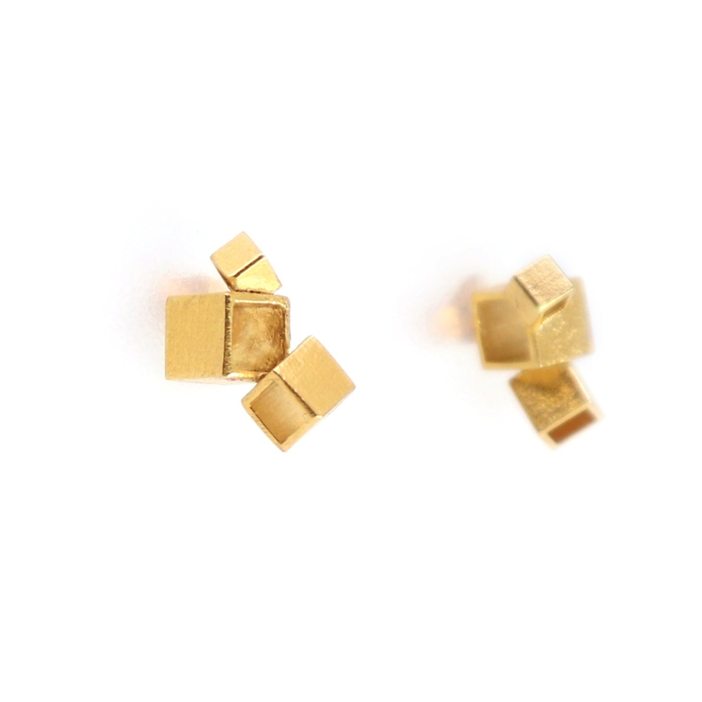 Gold geometric stud earrings on a white background