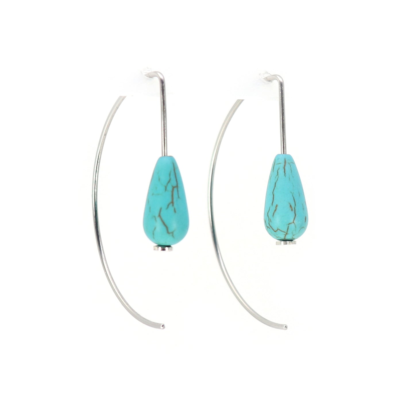 Turquoise teardrop earrings on curved wire against a white background