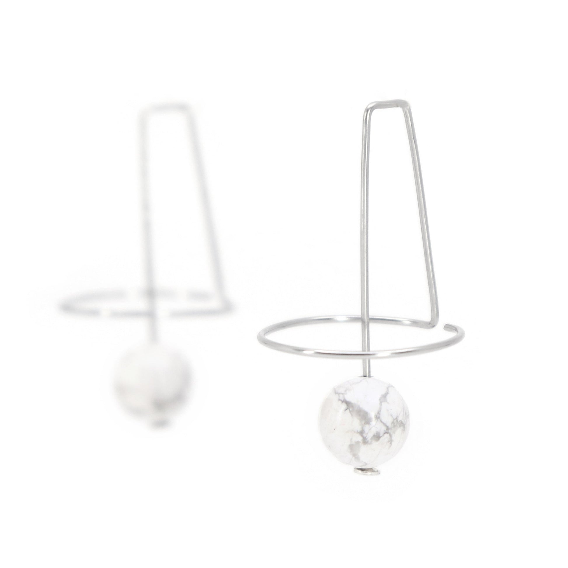 architectural unique wire earrings with howlite beads on white background