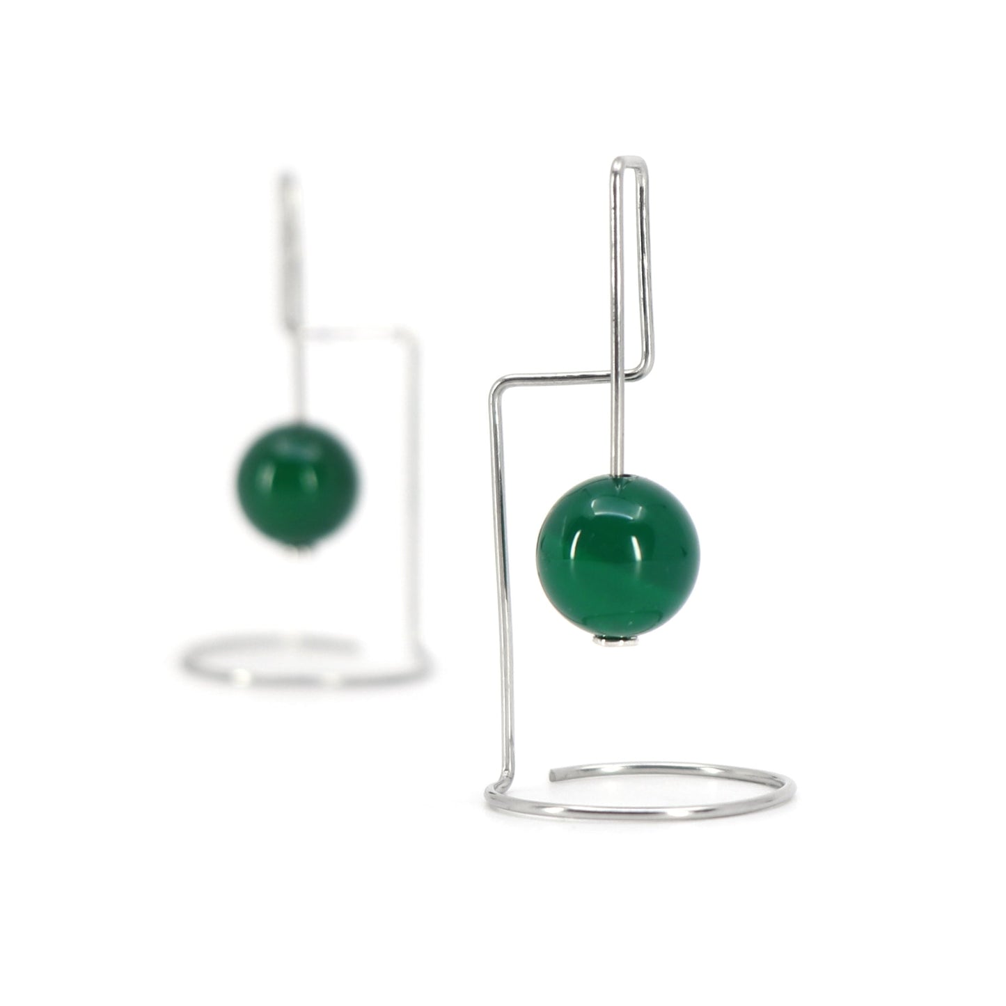Green agate bead earrings with geometric shaped wire against a white background