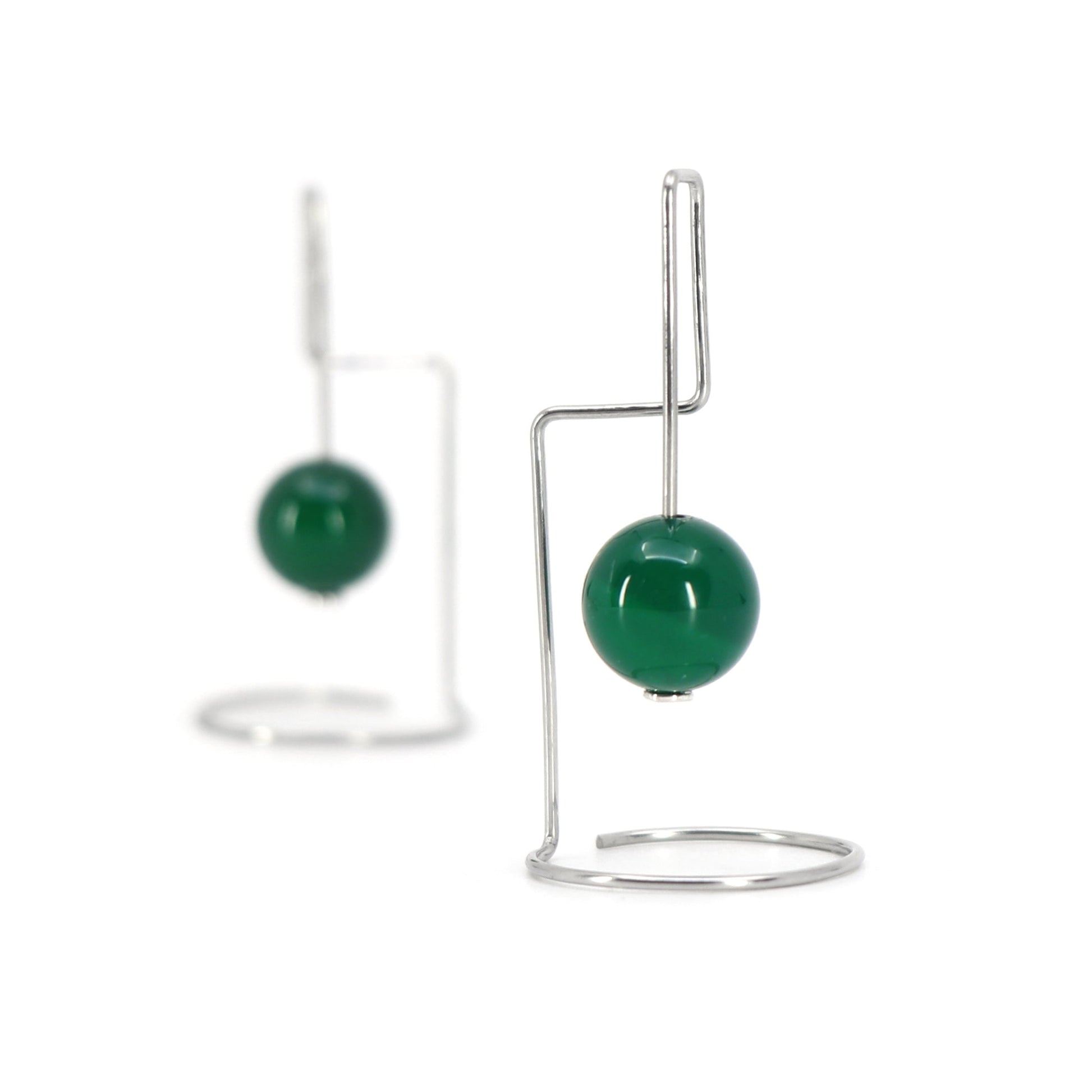 Green agate bead earrings with geometric shaped wire against a white background
