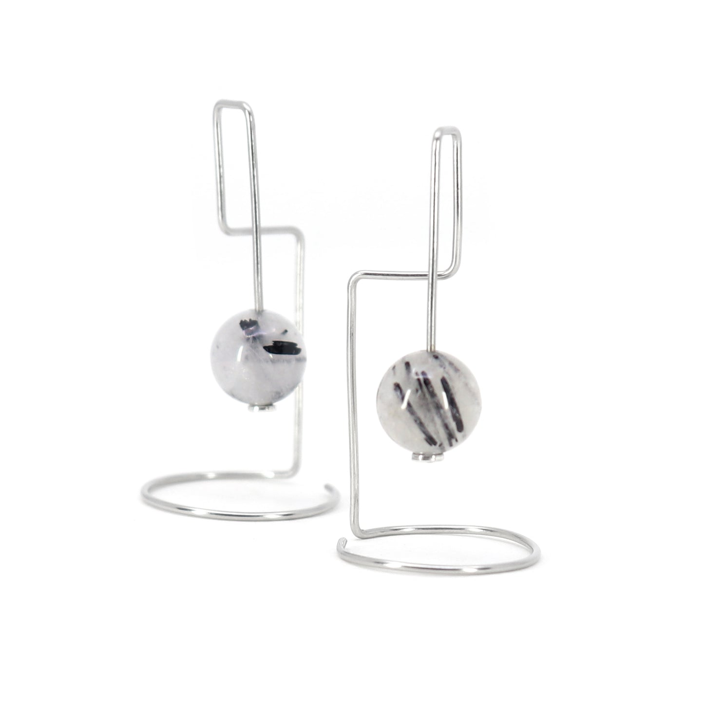 statement architectural rutilated quartz beads earrings on white background