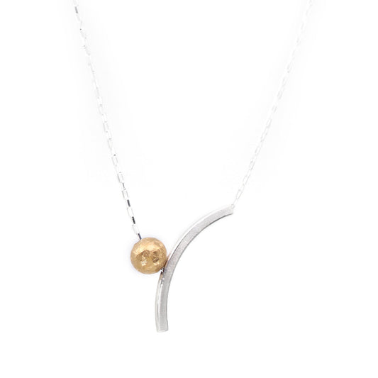 Necklace with a gold bead and curved silver pendant on a white background