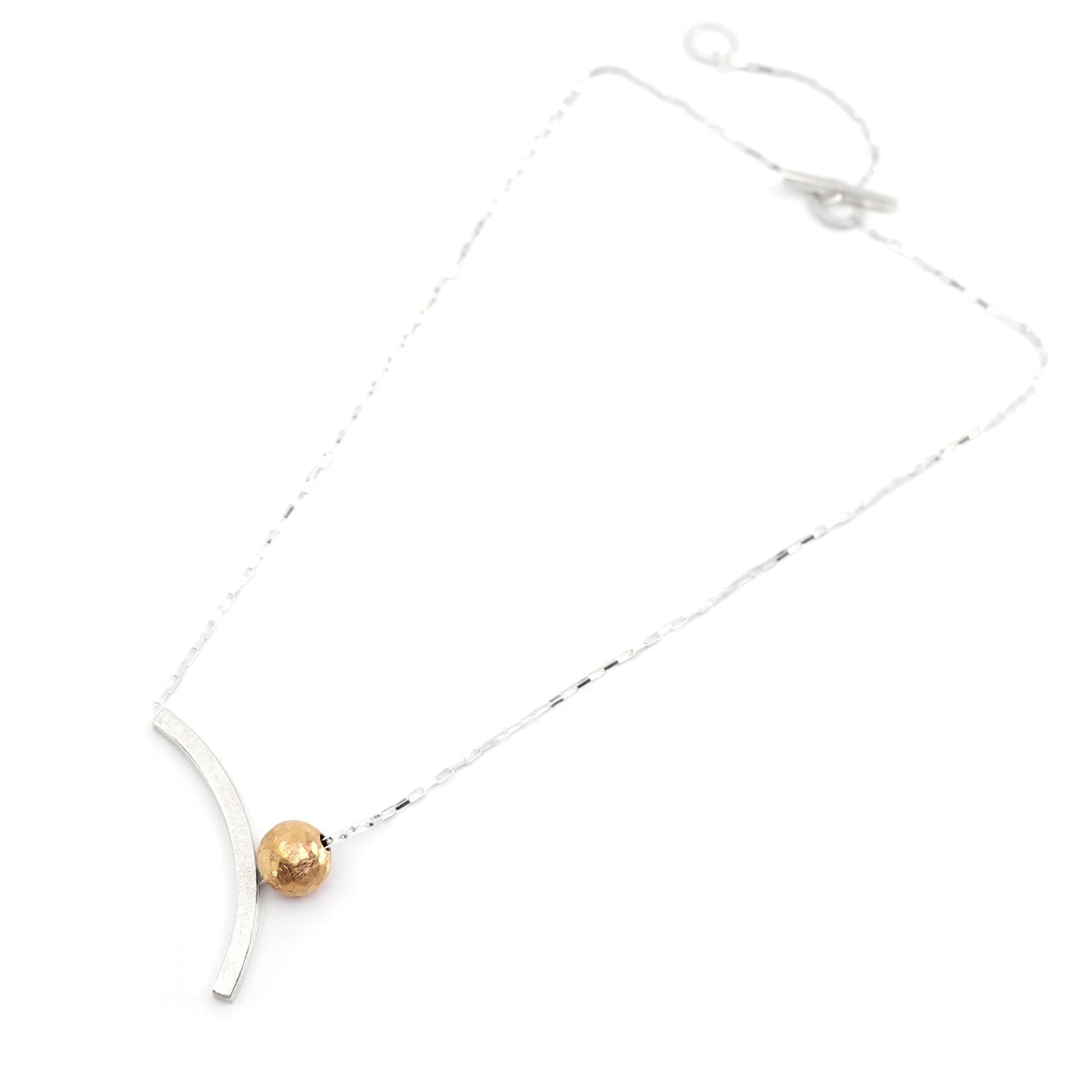 Bauhaus inspired necklace with a gold bead on sterling silver on a white background
