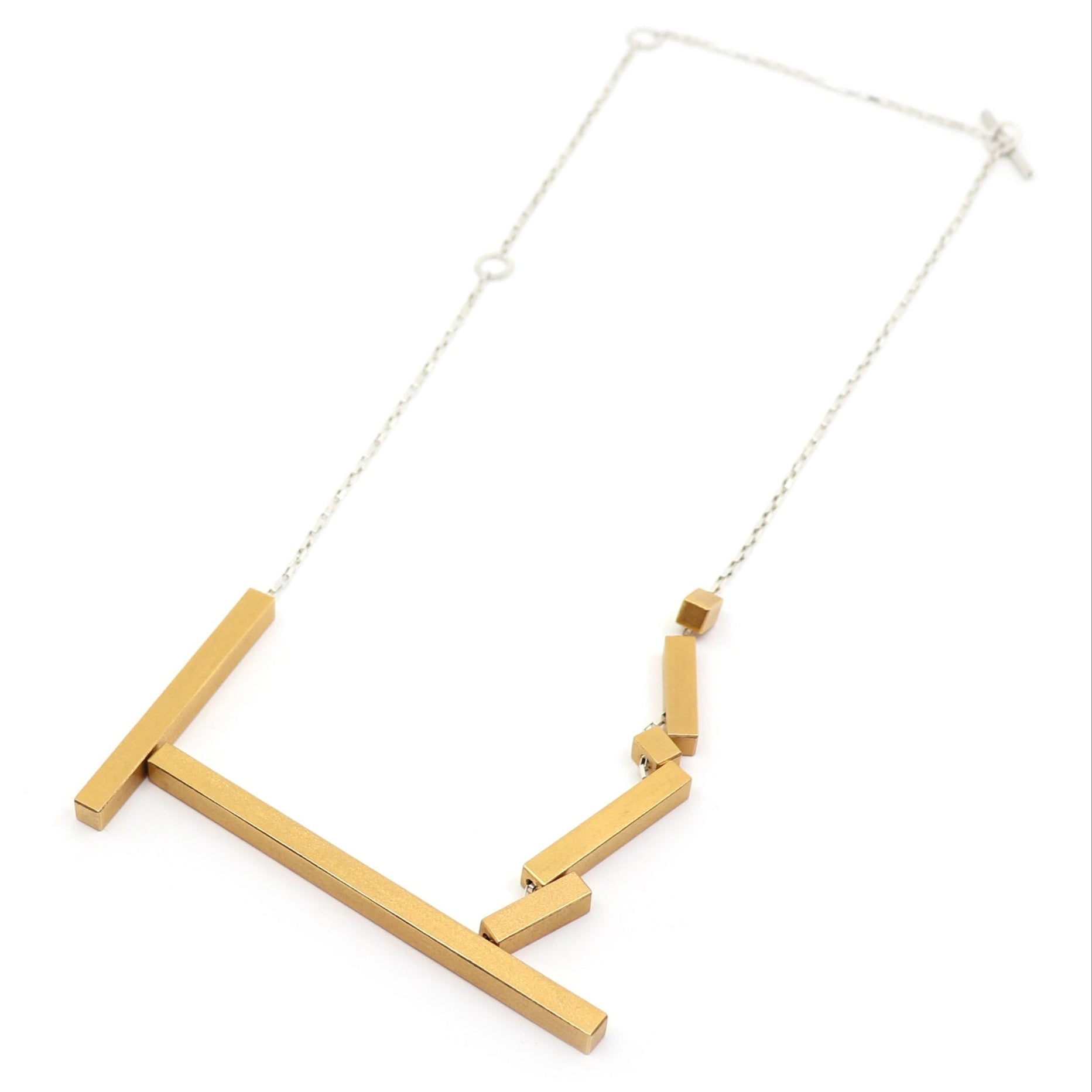 Gold necklace with geometric design on a white background