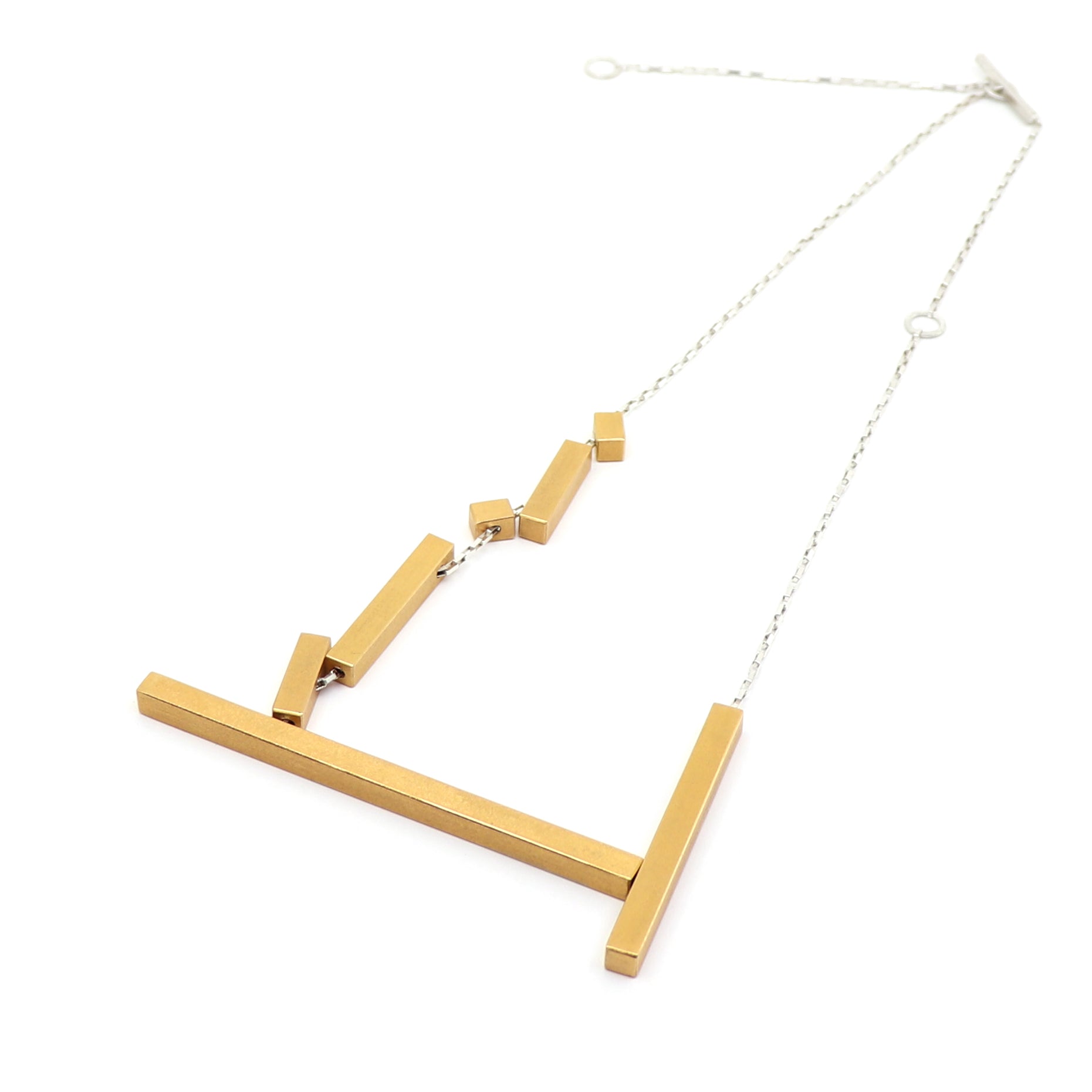 Gold necklace with geometric design on a white background