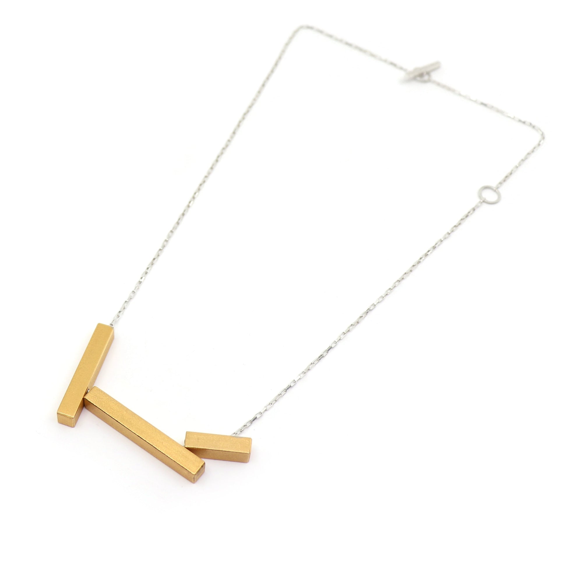 Necklace with gold bar pendants on silver chain white background