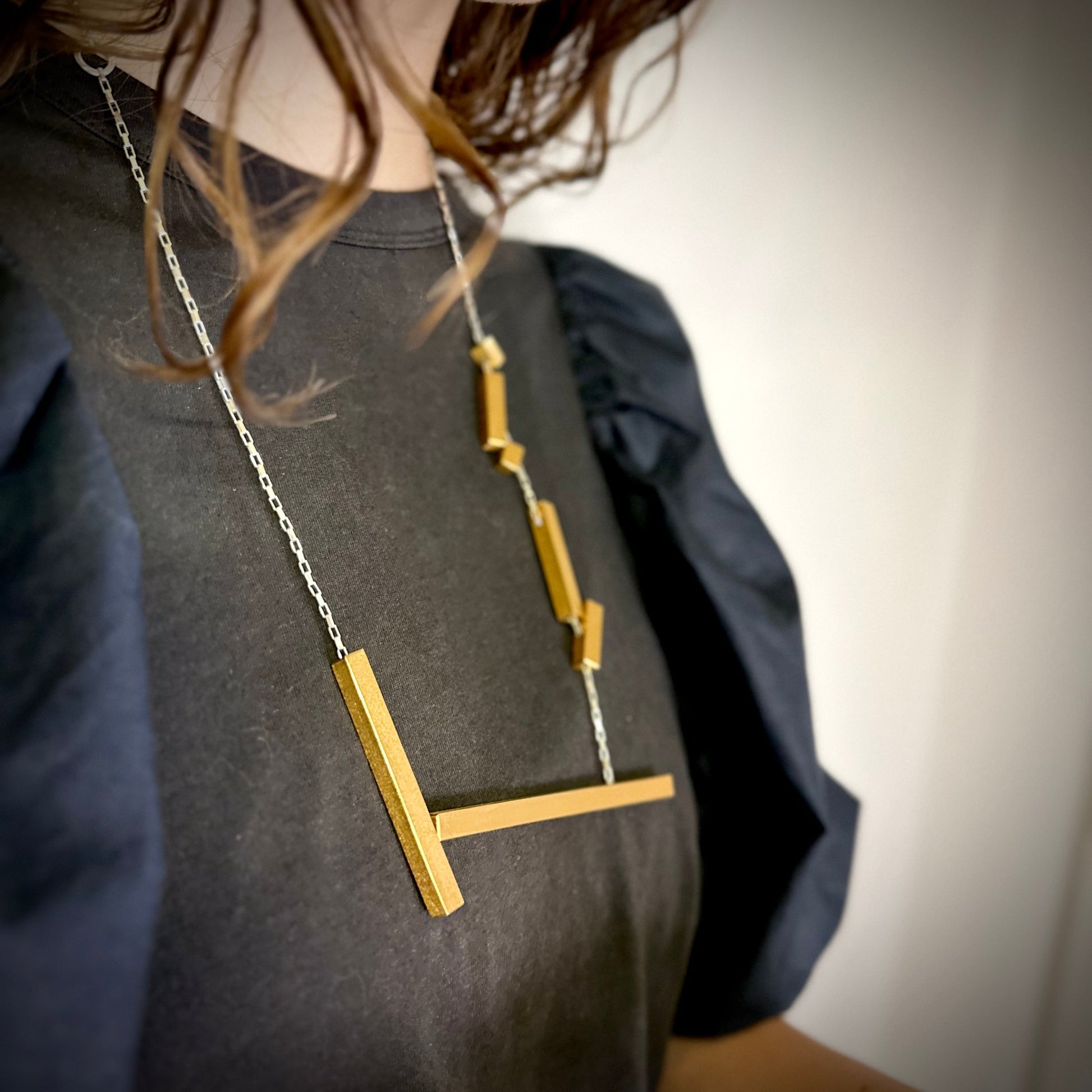 Modelled landslide gold and silver large statement necklace, adjustable chain worn long