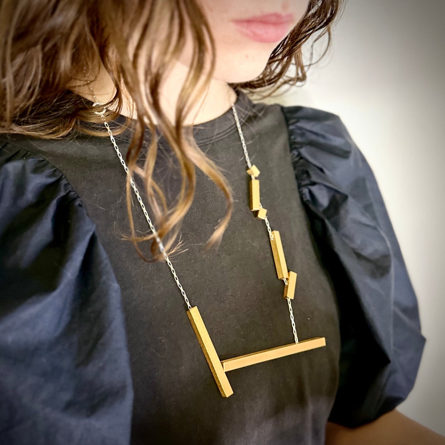 Modelled landslide gold and silver large statement necklace, adjustable chain worn long