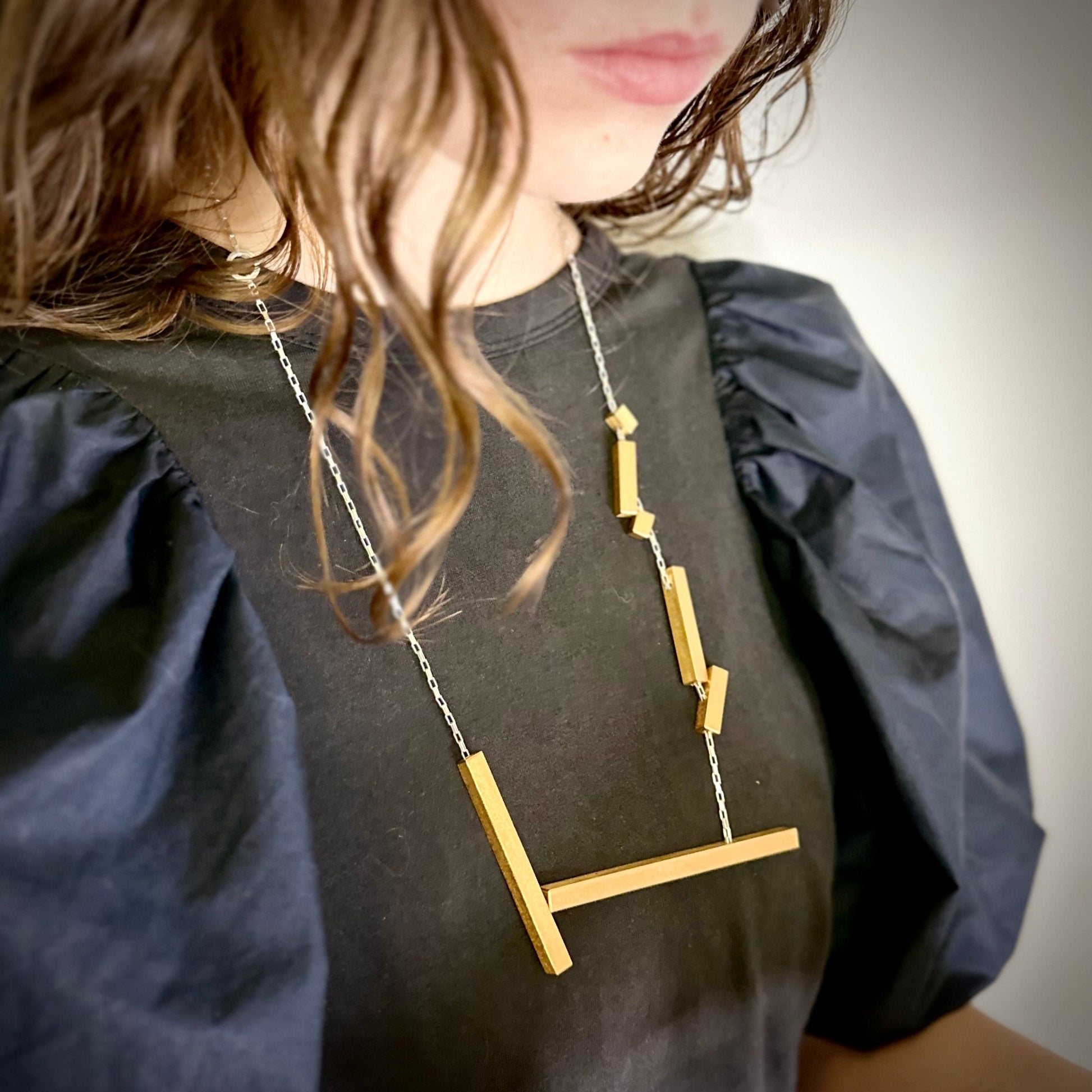 Modelled landslide gold and silver large statement necklace, adjustable chain worn long