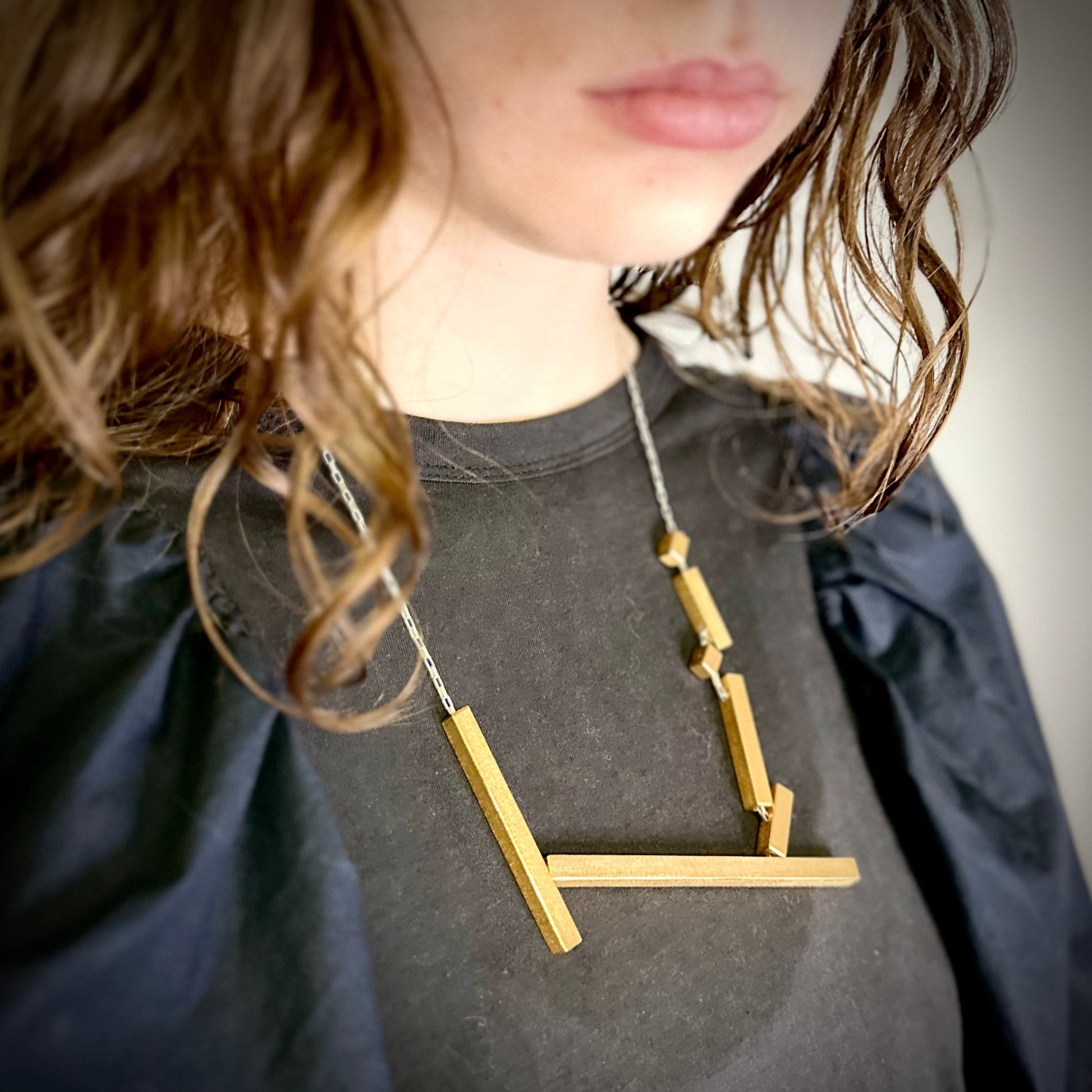 Modelled landslide gold and silver large statement geometric necklace, adjustable chain worn mid length