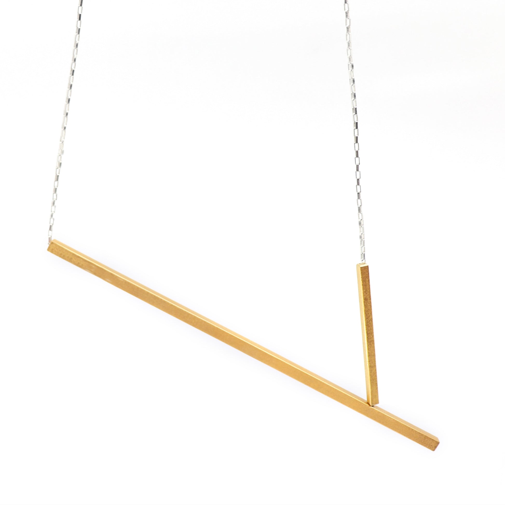 Gold necklace with two bars on a white background