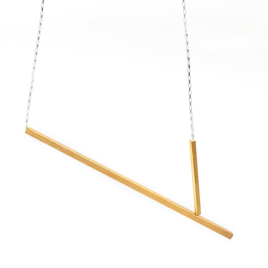 Gold necklace with two bars on a white background
