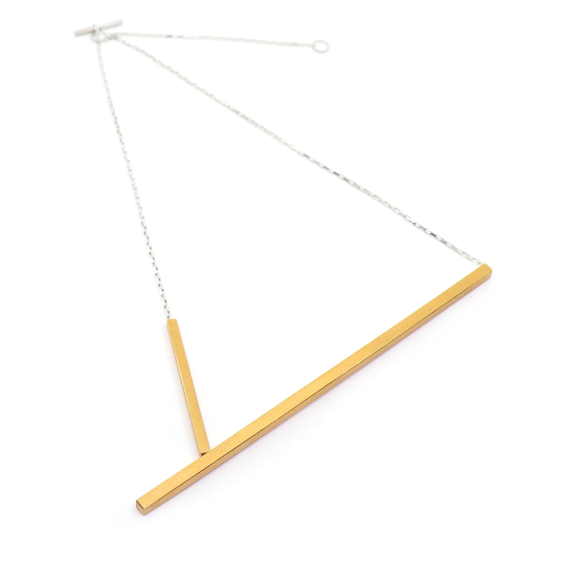 Necklace with a gold bar and silver chain on a white background