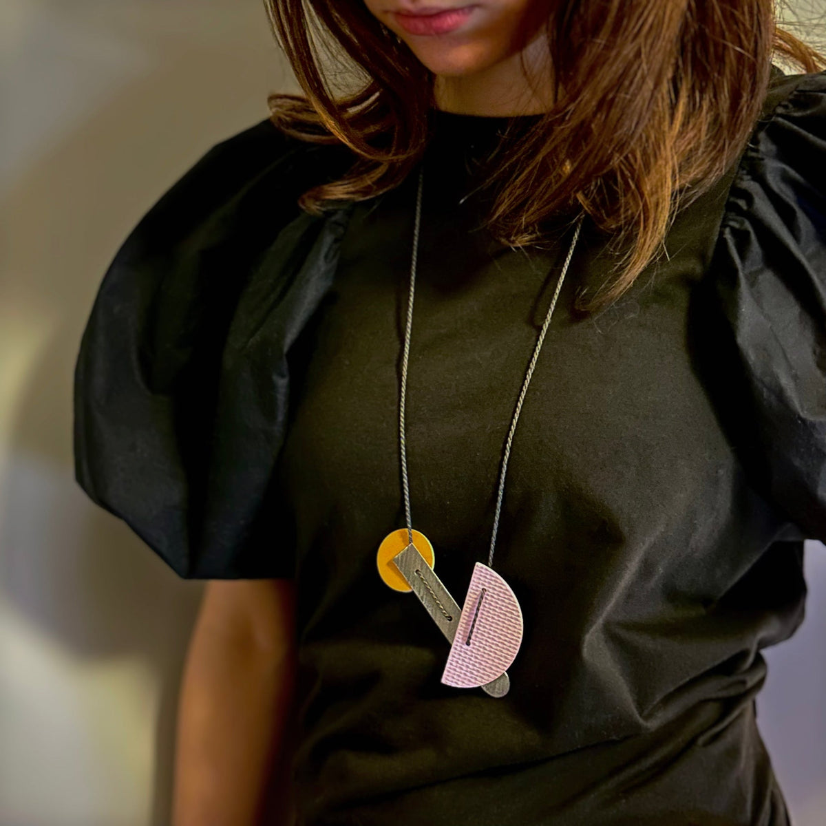 Long necklace made of linoleum in lilac, orange and steel