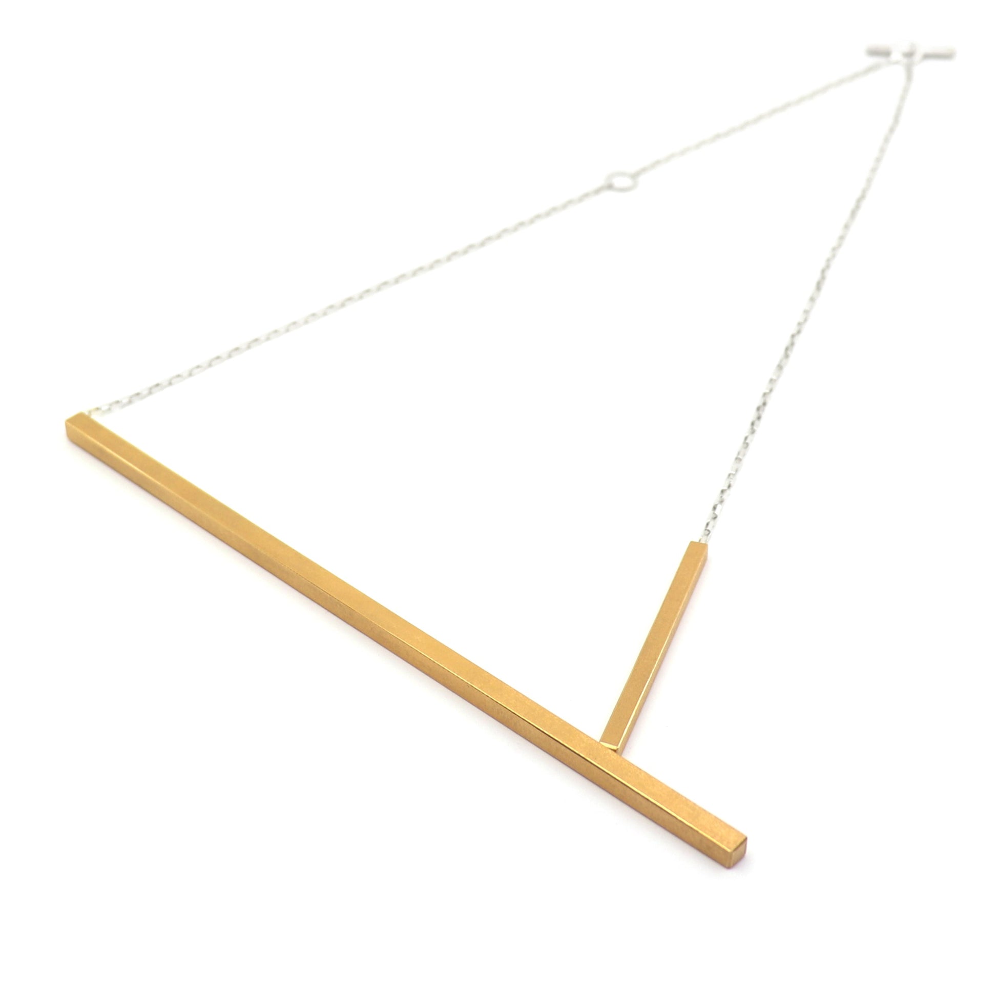 Gold bar necklace on a white background