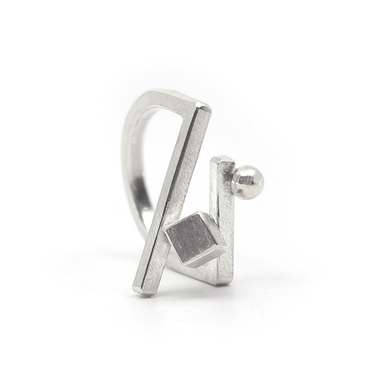 A silver geometric open ring with a textured finish, featuring a cube and a ball element, shown on a plain white background.