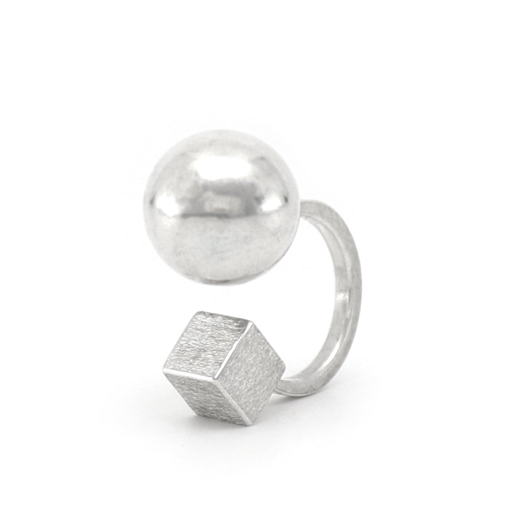 Silver ring with geometric design on a white background