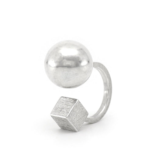 Silver ring with geometric design on a white background