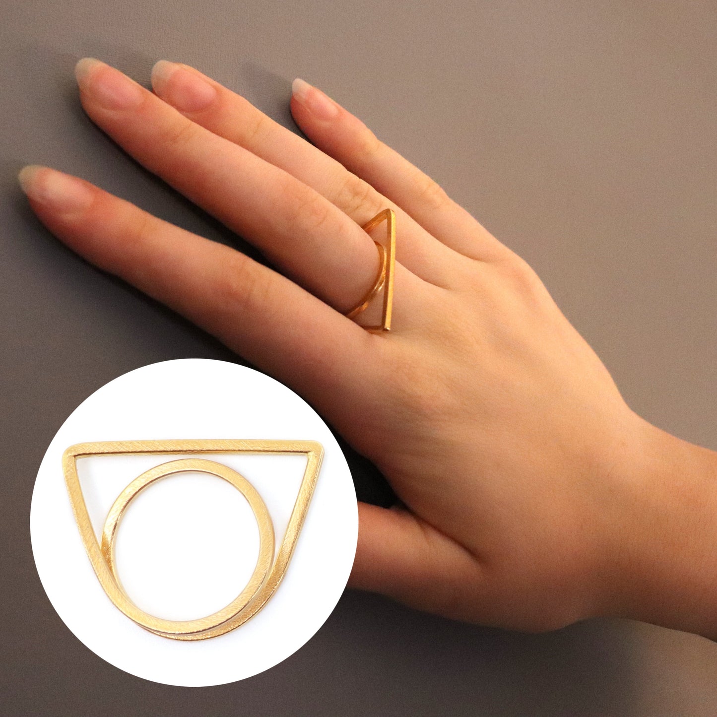 Gold geometric ring on a hand with a close-up inset of the ring.