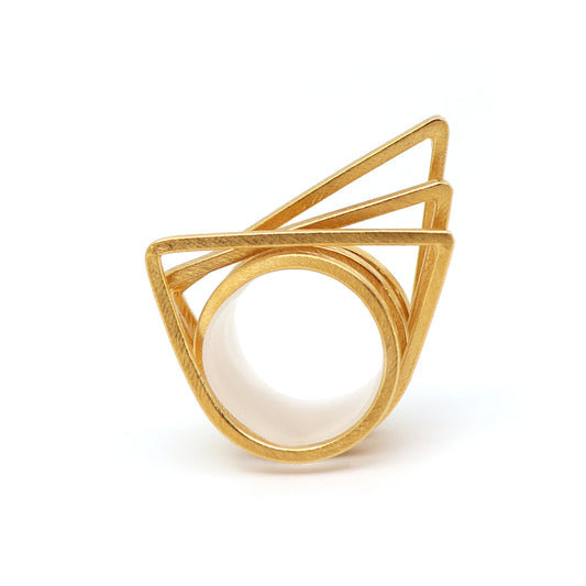 Stacking ring set of three gold geometric rings on a white background