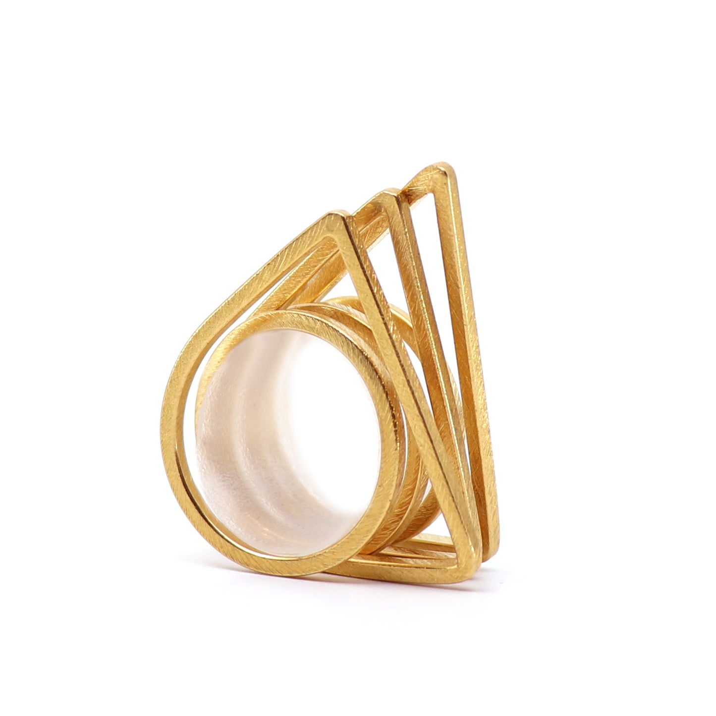 Gold ring set of three with geometric design on a white background
