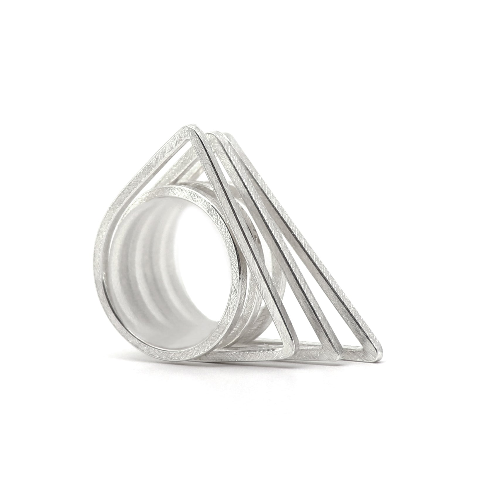Silver geometric ring set of three on a white background