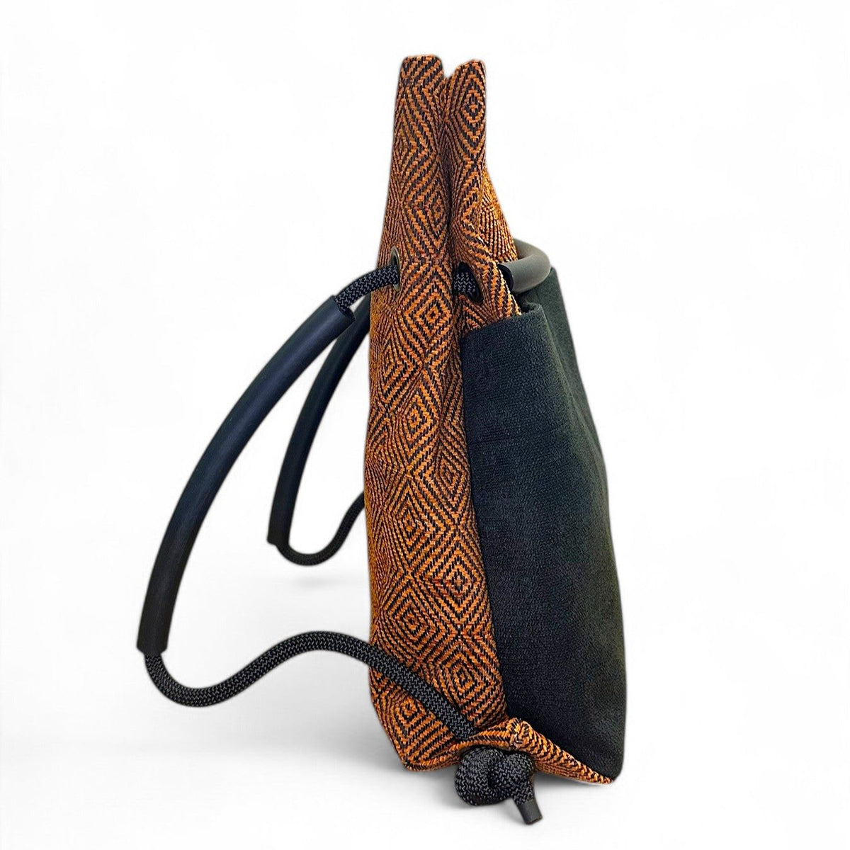 side view of Ditto orange & black geometric convertible backpack